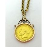 A George V gold half sovereign on a pendant and 9ct gold chain, total weight 15.4gms.