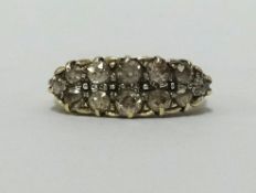 An antique 18ct twelve stone, old mine cut diamond ring, finger size R.