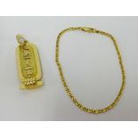 An Egyptian high grade gold pendant and chain, sold as 18ct approx 15.2gms.