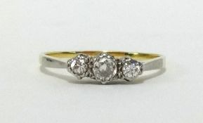 An 18ct three stone diamond ring, finger size T.