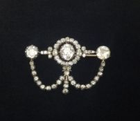 A stunning antique diamond trefoil drop brooch, set with an arrangement of round diamonds, the