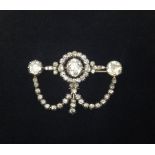 A stunning antique diamond trefoil drop brooch, set with an arrangement of round diamonds, the