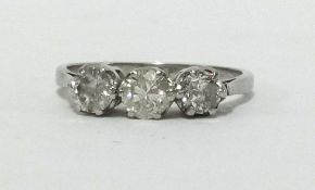 A platinum three stone diamond ring, finger size N.