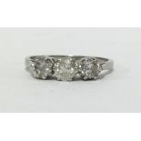 A platinum three stone diamond ring, finger size N.