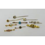 A collection of various gold and other tie pins including 15ct, also 9ct and 15ct gold brooches,