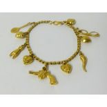 A Middle Eastern high carat gold charm bracelet, approx 16gms.