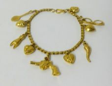 A Middle Eastern high carat gold charm bracelet, approx 16gms.