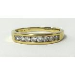A 9ct gold eternity ring, channel set with eight round cut diamonds, finger size N.