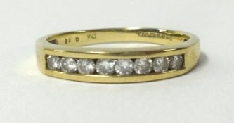 A 9ct gold eternity ring, channel set with eight round cut diamonds, finger size N.