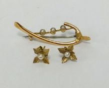 A 9ct and seed pearl set brooch, also a pair of similar earrings.