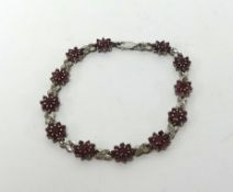 A silver and ruby set bracelet.