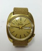 Bulova, a gents 9ct gold cased wristwatch day date with a 9ct Milanese bracelet, approx 74.5gms.