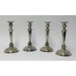 A set of four Georgian silver candlesticks, height 29cm.