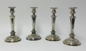 A set of four Georgian silver candlesticks, height 29cm.