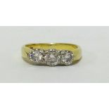 An 18ct three stone diamond ring comprising centre around brilliant cut diamond approx 0.50cts,