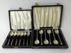 Two sets of six silver tea spoons in fitted original cases (2).