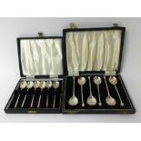 Two sets of six silver tea spoons in fitted original cases (2).