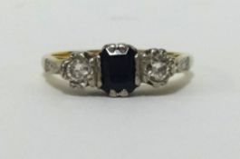 An 18ct sapphire and diamond three stone ring, finger size I.