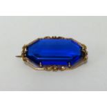 An antique brooch set with dark blue stone, overall brooch size approx 36mm x 20mm.