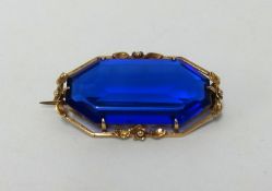 An antique brooch set with dark blue stone, overall brooch size approx 36mm x 20mm.