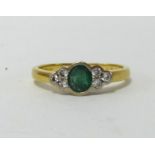 An 18ct emerald and diamond ring.