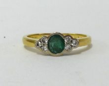 An 18ct emerald and diamond ring.