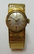 Omega, a ladies 9ct gold cased 'Ladymatic' wristwatch with gold bracelet.