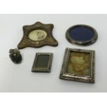 Five silver photo frames in various shapes and sizes, including Victorian.