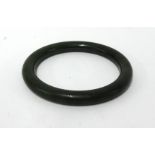 Jade, a dark green bangle, approx 8.50cm diameter.