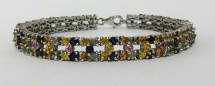 A multi sapphire silver bracelet, approx 23cm long.