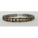 A multi sapphire silver bracelet, approx 23cm long.