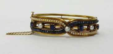 18ct gold and stone set bangle in crossover design, 16mm wide, 6cm x 5cm inner diameter