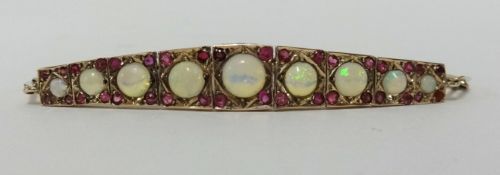 A nine stone opal and ruby set bracelet.
