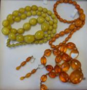Collection of three amber necklaces and gold amber earrings.