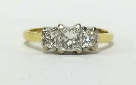 An 18ct three stone princess diamond cut ring, finger size O.