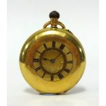 An 18ct gold half hunter small pocket watch with floral design gold dial and roman numerals, keyless