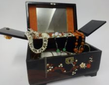 A collection of costume jewellery, in oriental lacquered box.