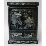 Oriental lacquered table cabinet with mother of pearl inlay.