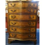 A reproduction mahogany serpentine chest, fitted with six drawers.