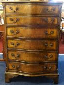 A reproduction mahogany serpentine chest, fitted with six drawers.