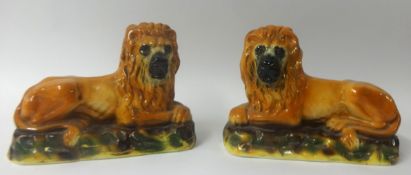 Pair 19th century Staffordshire pottery lions.