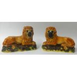 Pair 19th century Staffordshire pottery lions.