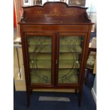An Edwardian mahogany two door display cabinet, with cross banded decoration through out, with