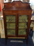 An Edwardian mahogany two door display cabinet, with cross banded decoration through out, with