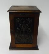 Tobacco carved oak cabinet fitted with a single drawer also jar and pipes.