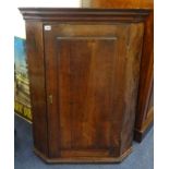 A Georgian oak and mahogany crossbanded hanging corner cabinet.