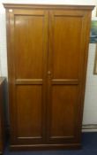 A two door mahogany cupboard with panel doors and sides.