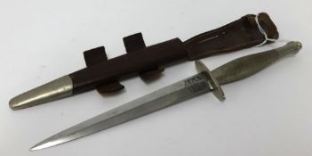 A Fairburn Sykes early second pattern commando fighting knife by Wilkinson with leather scabbard,