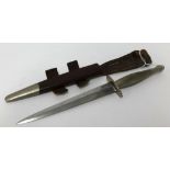 A Fairburn Sykes early second pattern commando fighting knife by Wilkinson with leather scabbard,