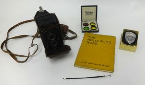 Rolleiflex camera and accessories including the Rolleiflex book.